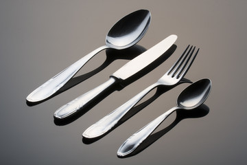 Metal cutlery on black background