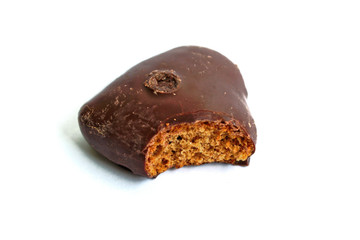 Chocolate gingerbread heart with a bite mark on a white background