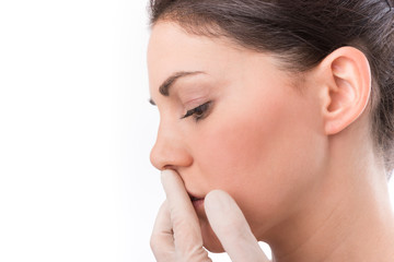 Beauty treatment of the young beautiful female face, doctor's hand in gloves touch nose of beautiful young woman isolated on white.