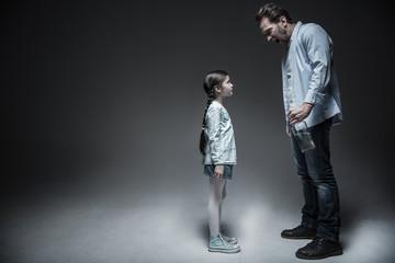Fototapeta premium Angry man while shouting on his daughter