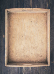 Empty rustic wooden box on table top view vertical. Toned