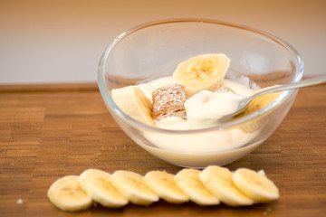 Breakfast yogurt in glass bowl with fruit and cereals