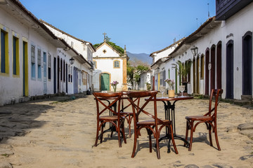 Street scene with table and chairs in historic colonial town Paraty, Brazil