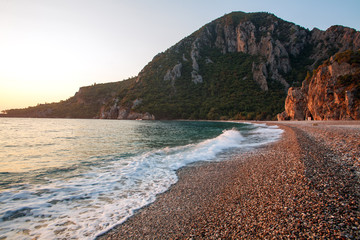 Coast of Mediterranean Sea on background of green mountains