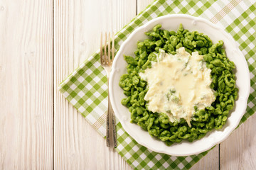 German dumplings (spaetzle) with spinach and cheese sauce.