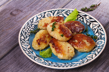Fish patties or cakes on blue plate. Fritters of fish. Healthy snack or take-away lunch bites