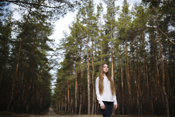 Red-haired girl with freckles walking with Husky dog in autumn forest. Other pet dog Husky