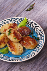Fish patties or cakes on blue plate. Fritters of fish. Healthy snack or take-away lunch bites