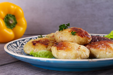 Fish patties or cakes on blue plate. Fritters of fish. Healthy snack or take-away lunch bites