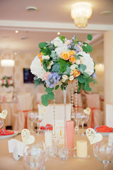 Wedding guest table decorated with bouquet and settings