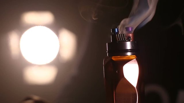 test burning the new dual coils on the atomizers deck base of electronic cigarette for vaping, close up scene