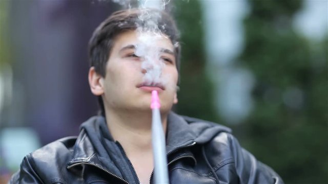 Young boy smoke the hookah