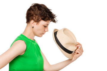 young girl with short hair holding a hat on a white background
