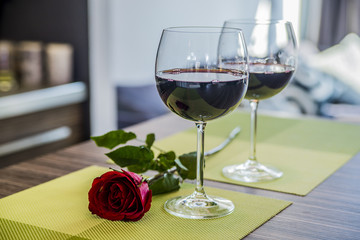 Valentines day: glasses of vine, red roses, for romantic evening