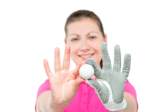 Young girl shows the ball for the game of golf on a white background
