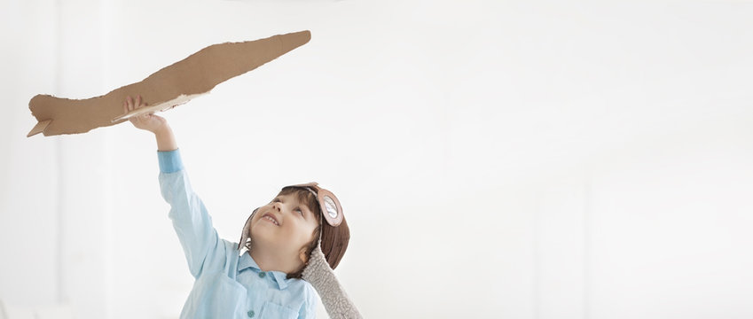 Happy Boy Play With Airplane In Hand, Child Dreams About Traveling By Aeroplane