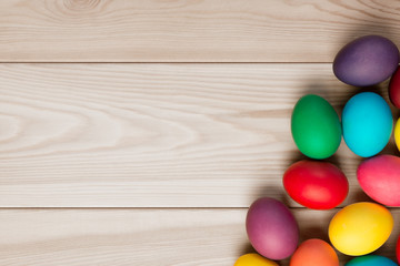 a wooden background for an inscription and a bunch of Easter eggs in the corner