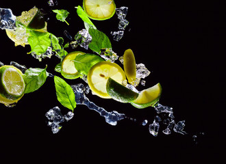 lime , lemon and  peppermint on a black background