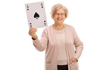 Happy mature woman showing an ace of spades card