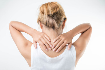 Young woman with pain in the back of her neck.,health care concept.