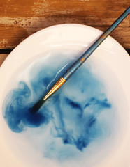 Brush closeup dip with watercolor paint