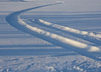 Tracks from car tires, snow road