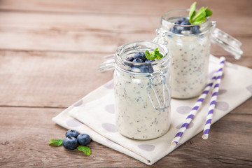 Smoothie in seeds of a chia and blueberry in a jar on a table. Selective focus. Copy space