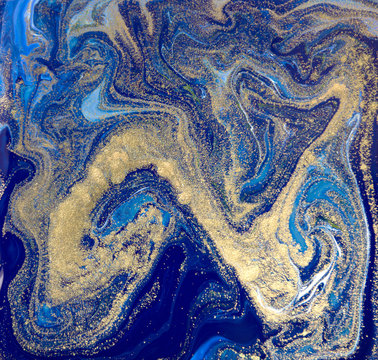 Blue and gold liquid texture. Hand drawn marbling background. Ink marble abstract pattern