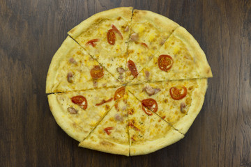 large pizza with tomatoes and cheese, with ham meat chicken with green sauce delicious fast food is bad food is bad food