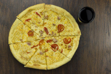 large pizza with coca tomatoes and cheese, with ham meat chicken with green sauce delicious fast food is bad food is bad food