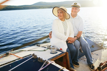 Restful senior couple having voyage on yacht