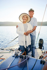Aged couple sailing on yacht during voyage