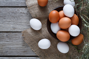 Fresh chicken brown eggs on sack, organic farming background