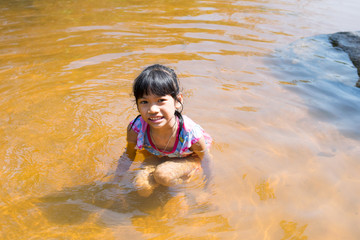 baby girl playing in river