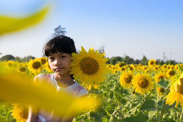 happy baby girl on sunflowers field