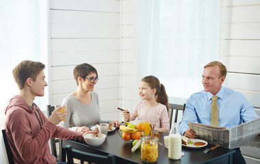 Healthy family of four having eco food for breakfast