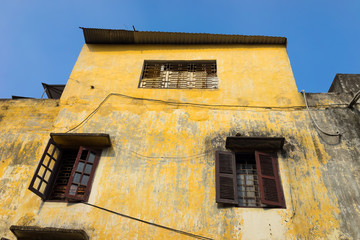 Yellow wall of aged classic style house in Hanoi, Vietnam