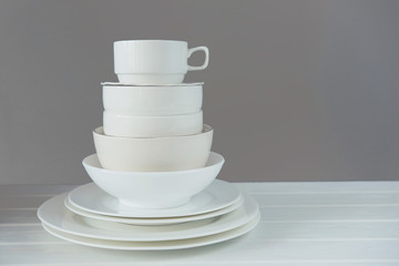 Minimalist picture of white porcelain kitchenware piled up