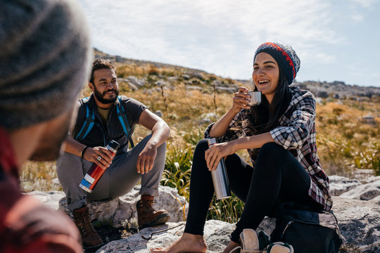 Young hikers relaxing and having coffee