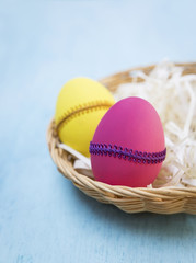 Closeup Easter egg in rattan basket, Easter background, vertical style