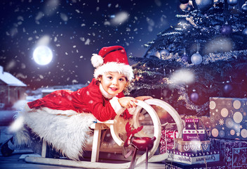 Portrait of the little girl playing sledge