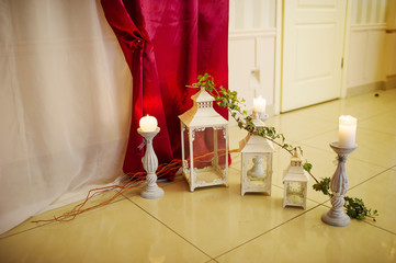 Candles and candlestick such as element of decor on great wedding hall.