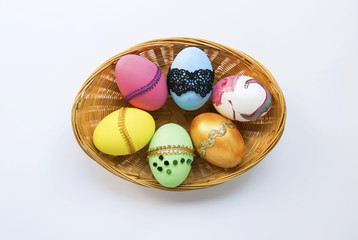 Beautiful design Easter egg collections in bamboo basket on white background