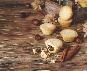 small round Christmas cakes with nuts and cinnamon, space for text