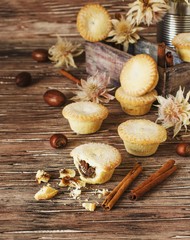 Fototapeta na wymiar small round Christmas cakes with nuts and cinnamon, space for text