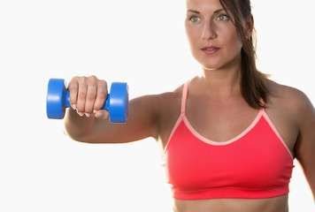 Athletic woman works out with dumbbells isolated over white background