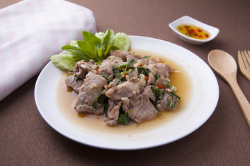 Pock stir fried with basil leaves, chilli and garlic.