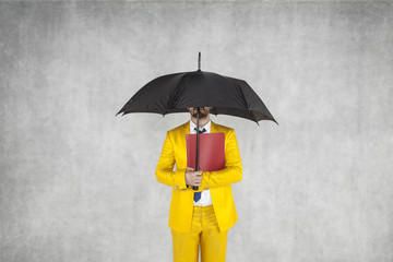 businessman protects the data, is under the umbrella