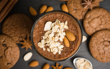 Chocolate smoothie with bananas and cookies on the dark wooden background