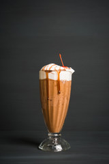 Chocolate smoothie with bananas on the dark wooden background